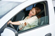Woman is talking on the phone while driving a car. The concept of danger on the road and inattentive car driving