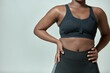 © Georgii - African american girl wearing sportive clothes showing torso with fat folds, closeup, copyspace. Body positive, slimming