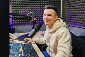 A sports speaker is conduct a live broadcast in a radio studio.