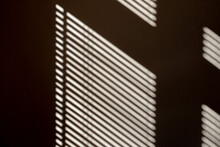 Light And Shadow Concept, The Sunlight Shines Through The Venetian Blinds On The Concrete Wall, Dual Toned Of Black And White In Oblique Line, Wavy Steel Stripes Design, Abstract Background.