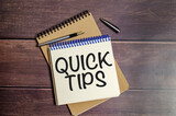 Fototapeta  - QUICK TIPS words on notebook on wooden background