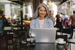© Kostiantyn - Happy mature lady working at city cafe