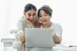 © David - Happy lgbt gay couple of Asian women having fun using a computer laptop at home - LGBT lesbian relationship, Asian LGBTQ female lesbian concept.