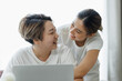 © David - Happy lgbt gay couple of Asian women having fun using a computer laptop at home - LGBT lesbian relationship, Asian LGBTQ female lesbian concept.