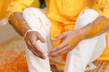 Wall Mural - groom hands in turmeric paste in haldi ceremony 