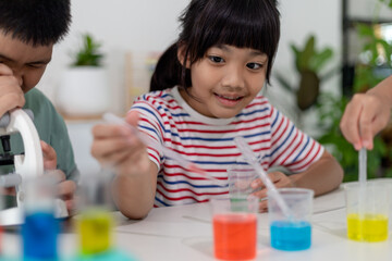 Asian Children enthusiastically watch chemistry experiments.