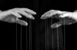 Man hands with strings on fingers. Manipulation, control, power, abuse concept. Black and white. High quality photo