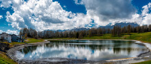 Alpine Lake In Spring Season With Clouds In The Blue Sky