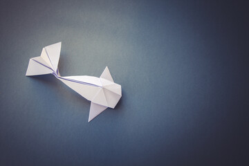 Wall Mural - white paper fish origami isolated on a grey background