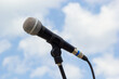 Microphone on sky background. The microphone is on the street. Concept - street music. Sound equipment