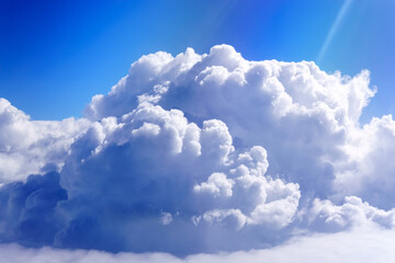 Wall Mural - white fluffy clouds below. top view from the window of an airplane flying in the clouds. selective f