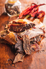 Canvas Print - Beef jerky meat. Dried sliced meat on wooden table.