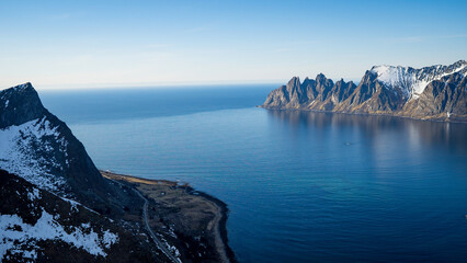 Norwegian nortern fjords, Ersfjorden and Bergsfjorden, and small town tucked away among hills. Viewpoint from Husfjellet, Senja island. Tourism, travel concept.