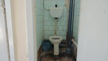 An Old Abandoned Toilet And A Toilet Room In Need Of Major Repairs. Toilet Used In The Russian Federation