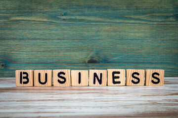Wall Mural - business. wooden alphabet letters on a green and white background