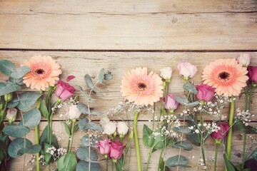 Wall Mural - Beautiful bouquet with gerberas and lisianthus on old wooden background - greeting card - mother's day, birthday, wedding - top view with copy space