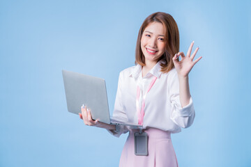 Wall Mural - Image of young Asian businesswoman on blue background