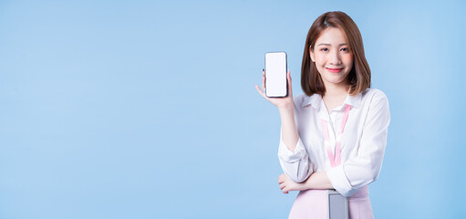 Wall Mural - Image of young Asian businesswoman on blue background