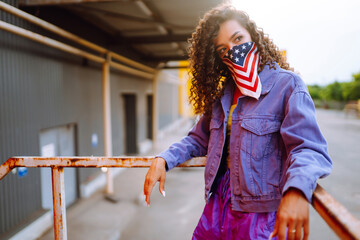 Street dancer in stylish clothes with american bandana dancing and showing some moves. Sport, dancing and urban culture concept.