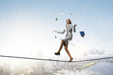 Fototapeta Sport - Young pretty businesswoman juggling with business items