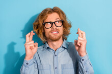 Photo Of Worried Person Crossed Fingers Look Interested Empty Space Isolated On Blue Color Background
