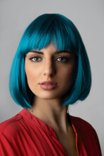 Beauty, Fashion, Makeup Concept. Close-up Studio Portrait Of Beautiful And Sexy Woman In Blue Wig And Red Shirt Looking To The Camera. Woman With Blue Eyes And Pink Lipstick With Sensual Look