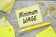 Minimum wage on paper sticker near paperclips