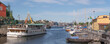 Pier with boats at the canal Beckholmskanalen a sunny summer day in Stockholm