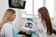 © Tania - The dentist shows the x-ray image to the patient. People, medicine, dentistry, technology and healthcare concept.