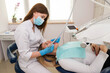 © Tania - Dentist-hygienist conducts a teeth cleaning procedure for a girl in a dental clinic. Removal of tartar.