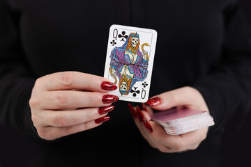 Female hands hold a deck of cards and show tricks.
The photographer is the author of the design of playing cards, which is written in the release of the property.