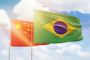 Wall Mural - Sunny blue sky and flags of brazil and china