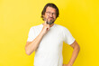 © luismolinero - Senior dutch man isolated on yellow background and thinking