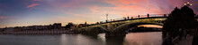 Panoramic View Of A Sunset By The Triana Bridge 
