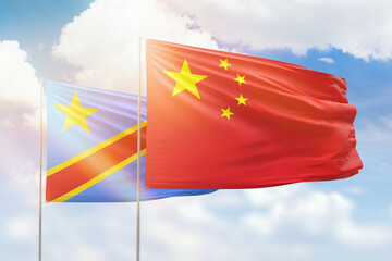 Sunny blue sky and flags of china and dr congo