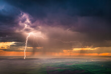 While High Atop Steptoe Butte, A Late Spring Lightning Storm Passes Over The Agricultural Fields Of Eastern Washington's Palouse Region, USA.