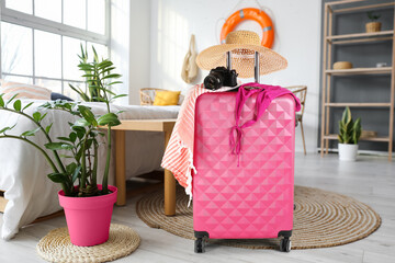 Poster - Packed suitcase in bedroom. Travel concept