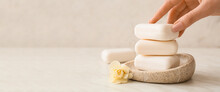 Female Hand With Soap Bars On Light Background With Space For Text