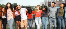 Group Of 20s Multiethnic Young Friends Hugging In The Park Talking And Joking Together - Multicultural People Standing Hands On Shoulders Together - People Lifestyle Concept