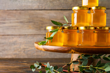 Wall Mural - Jars with honey on wooden background