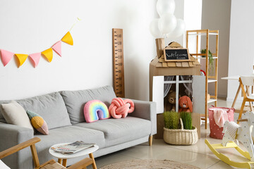 Sticker - Interior of playroom with sofa, toys and cardboard house