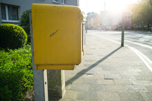 Yellow Mailbox For Letters On The Street Of A Provincial Town, In The Sunlight. 