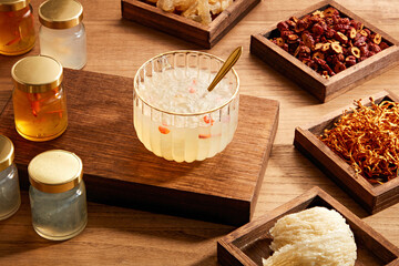 Wall Mural - Front view of birdnest bowl with goji berry with cordycep in wooden table background  