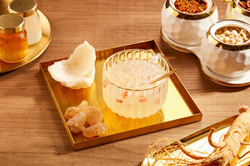 Wall Mural - Front view of birdnest bowl with goji berry with cordycep in wooden table background  