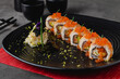 © yalcinsonat - Sushi set of various products on a black stone plate. Blur background and selective focus