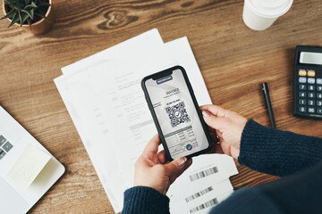 Fototapete - Woman paying invoice scanning QR code from document using fast secure payment system and smartphone QR scanner. Business woman paying bills using express payment technology. Paying expenses online