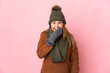 © luismolinero - Middle age woman with winter hat isolated on pink background happy and smiling covering mouth with hand