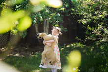 Cute European Kid Girl In Dress With Soft Big Toy Dog In Backyard, In Park Summer