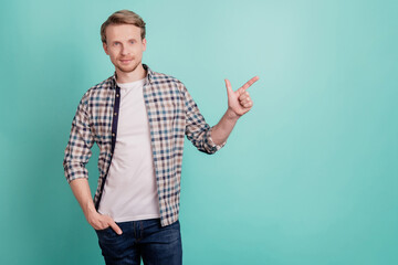 Wall Mural - Photo of confident promoter man indicate finger sale banner wear plaid shirt on teal color background