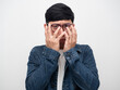 © Thanasak - Portrait man jeans shirt wearing glasses hand close his face,Man hide his face